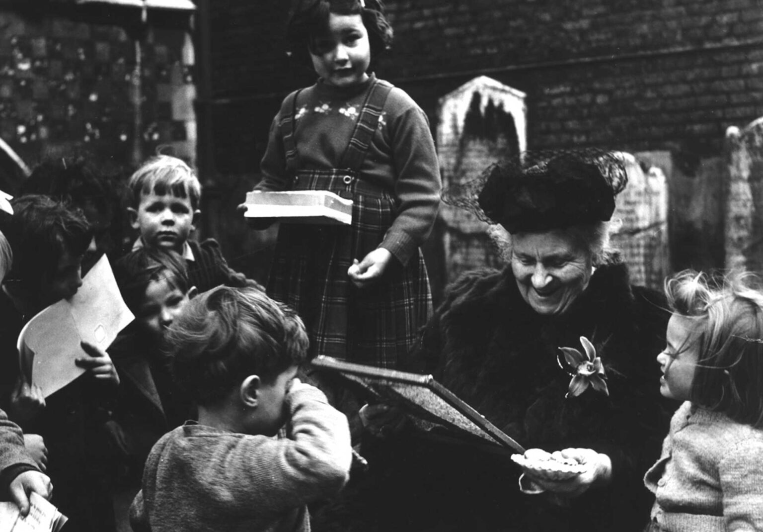 Maria Montessori reading to school children
